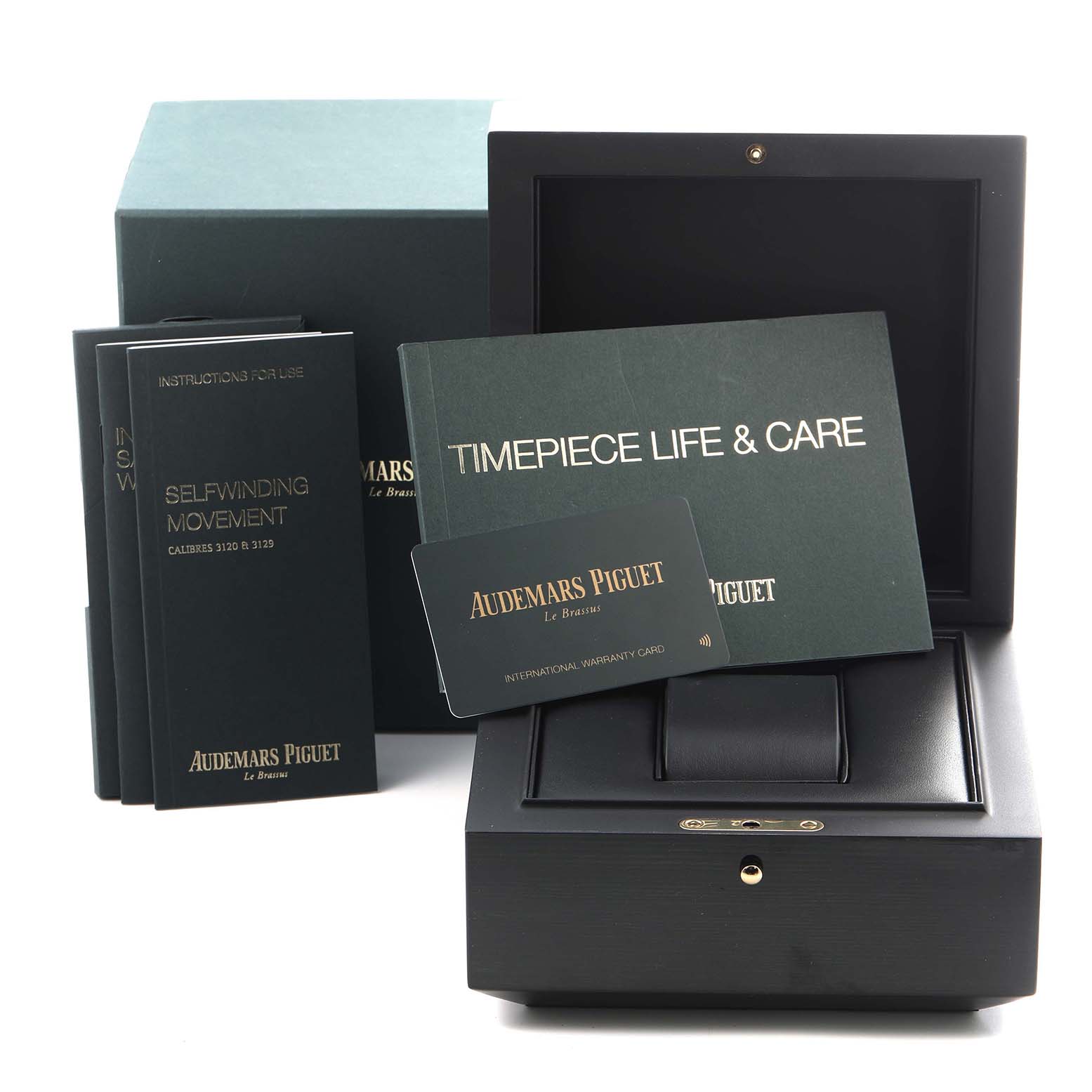 This image shows a black presentation box, instruction booklets, and warranty card for the Audemars Piguet Royal Oak 15451BA.ZZ.1256BA.01 Men's Yellow Gold Blue Dial 15451BA.ZZ.1256BA.01 Men's Yellow Gold Blue Dial watch.