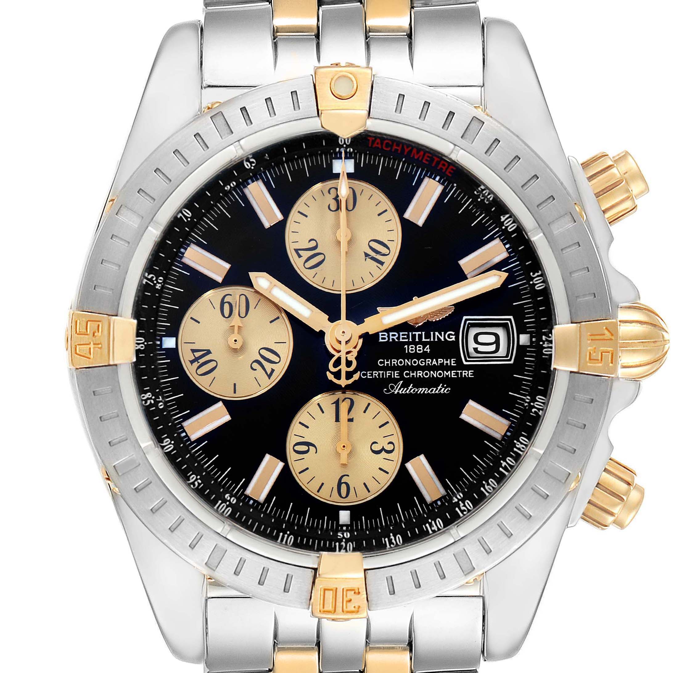 The Breitling Chronomat B13356 Men's Steel and Gold (two tone) Black Dial B13356 Men's Steel and Gold (two tone) Black Dial watch is shown from a front angle, displaying its dial, bezel, crown, and pushers.