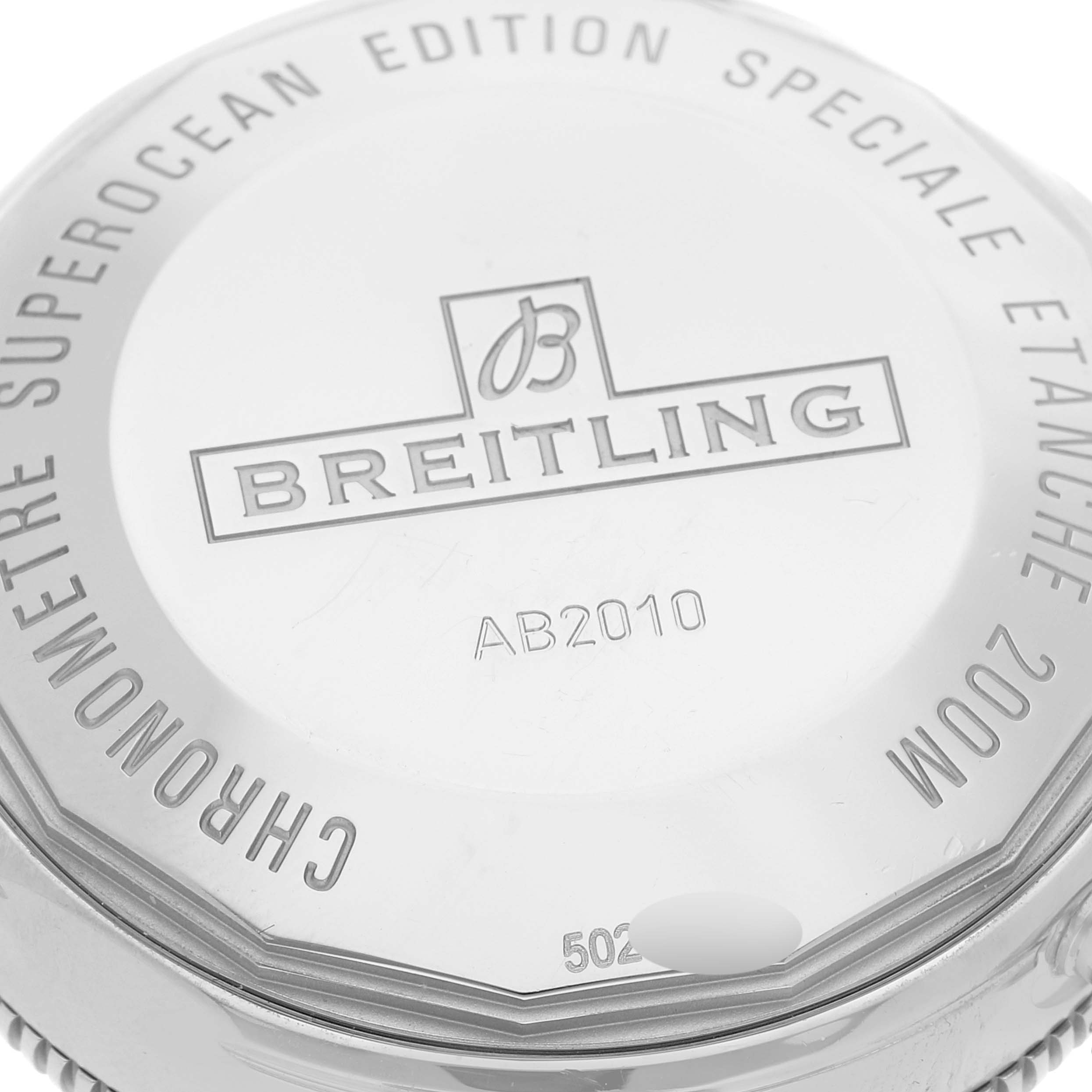 The image shows the case back of a Breitling Superocean AB2010 Men's Stainless Steel Beige Dial AB2010 Men's Stainless Steel Beige Dial watch, highlighting the brand logo and model number AB2010.
