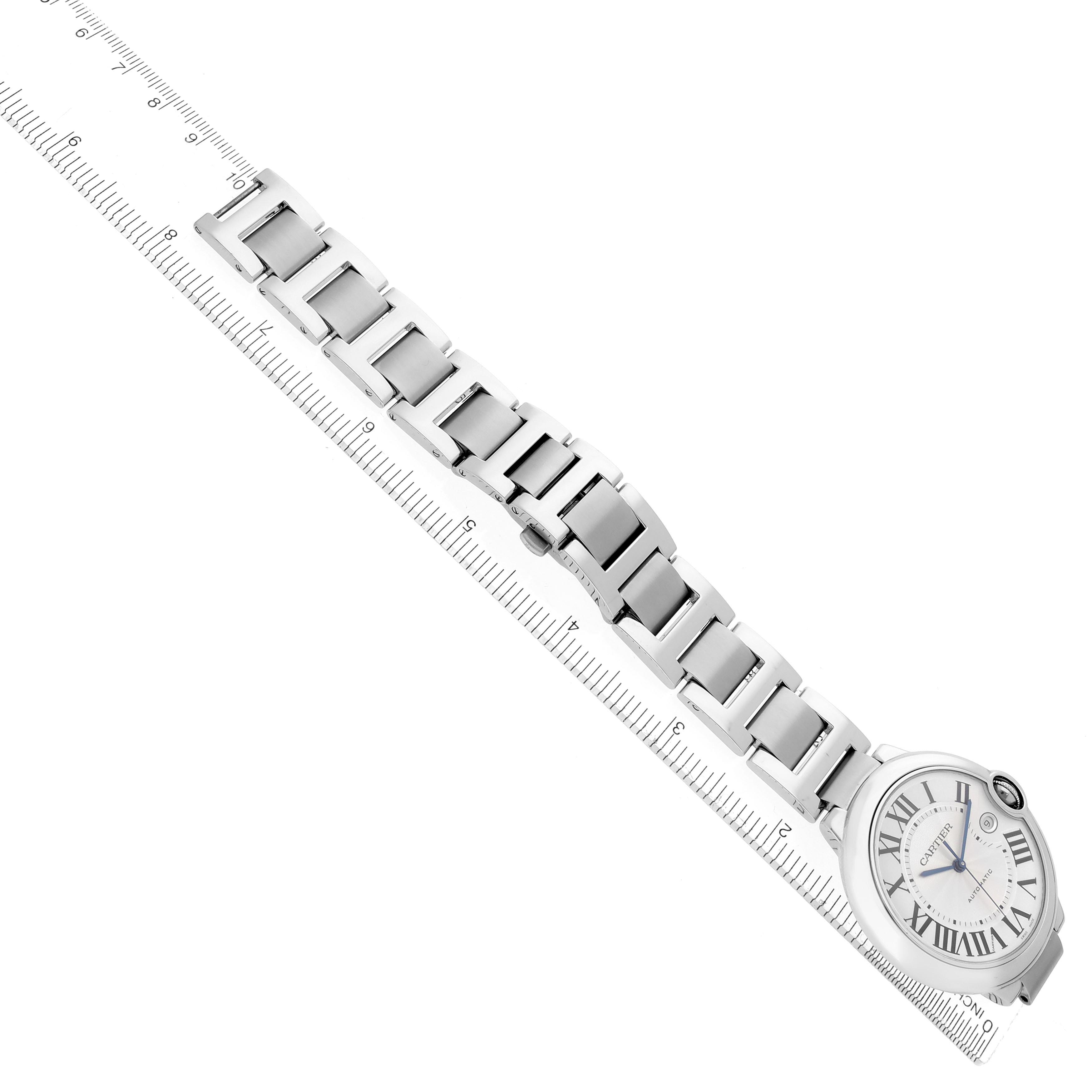 The Ballon Bleu by Cartier is shown from an angled top view, displaying the entire watch and bracelet next to a ruler.