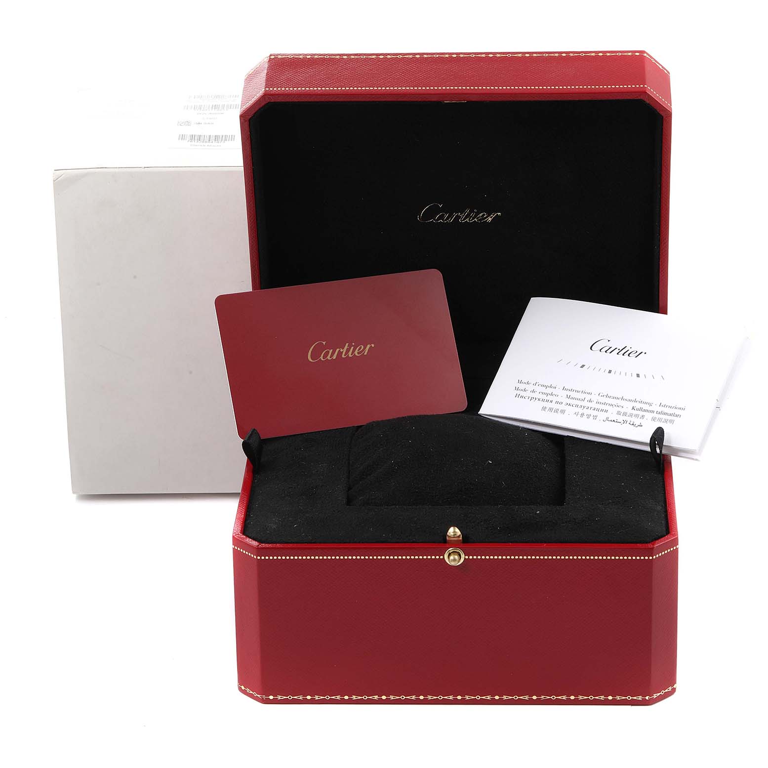 The image shows the open box of a Calibre de Cartier watch by Cartier, including warranty cards and booklets.
