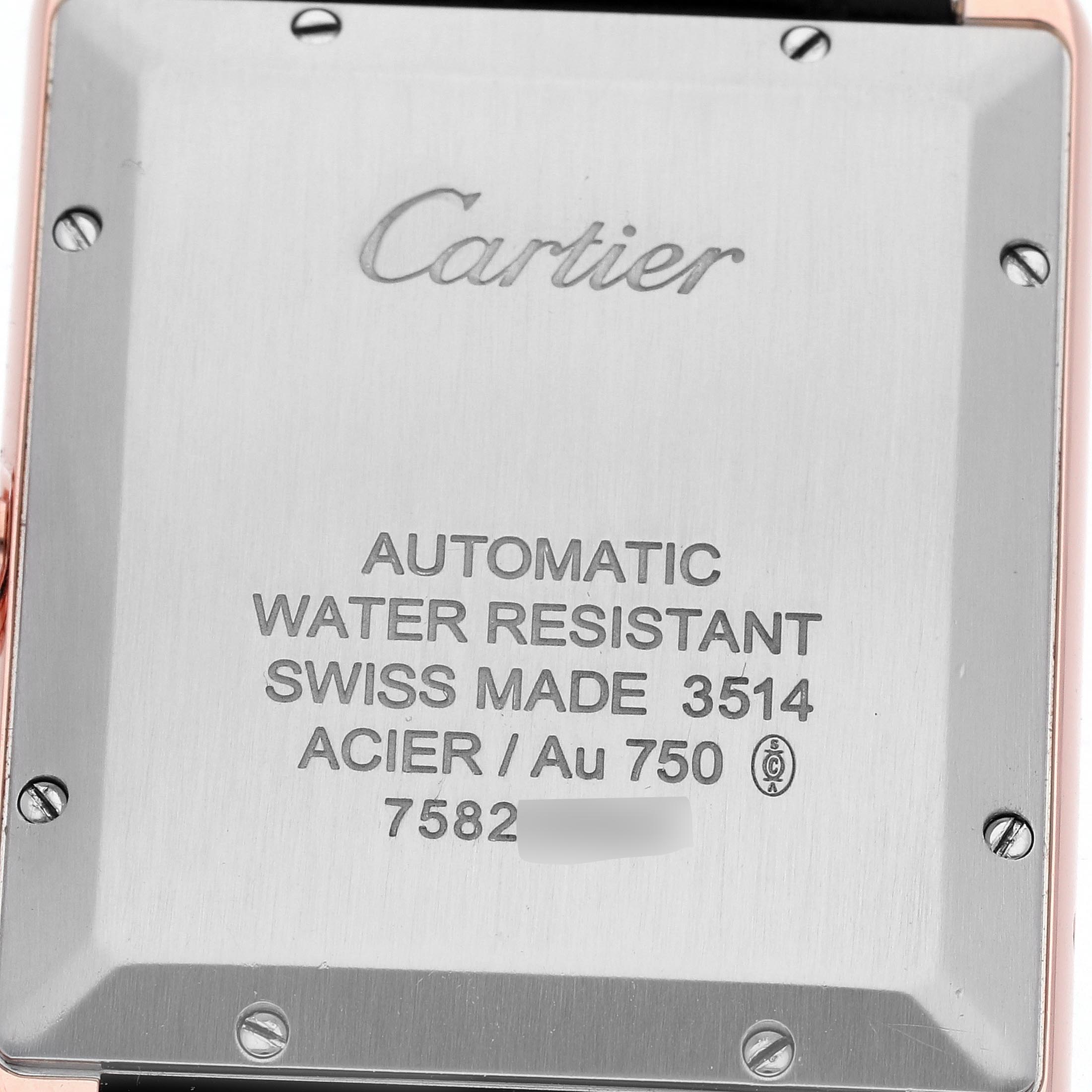 The image shows the back plate of the Cartier Tank Solo W5200026 Men
s Steel and Gold (two tone) Silver Dial W5200026 Men
s Steel and Gold (two tone) Silver Dial watch, featuring engravings and screws.