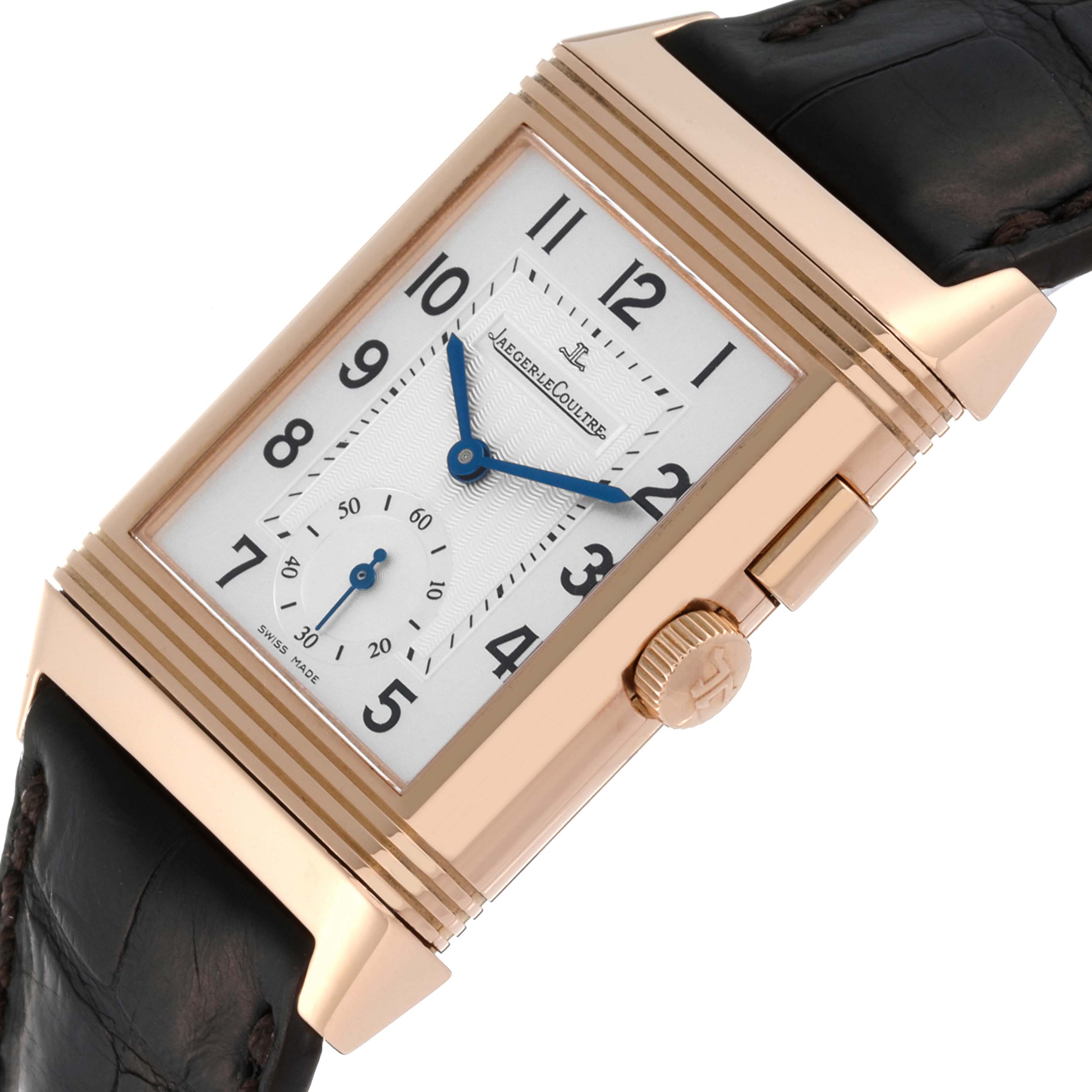 The image shows a close-up, angled view of the Jaeger-LeCoultre Reverso watch displaying its face, crown, and leather strap.