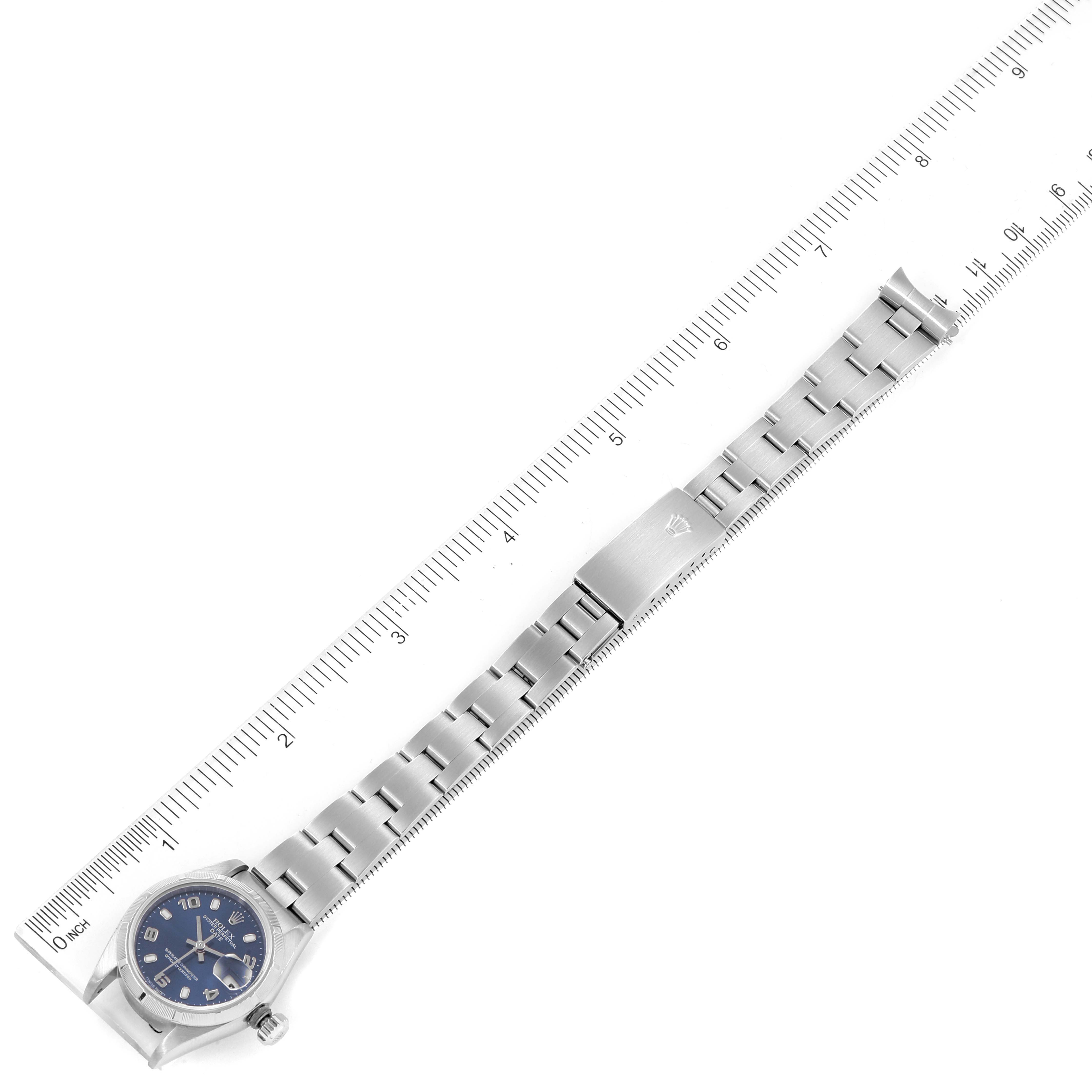 The Rolex Date 79190 Women's Stainless Steel Blue Dial 79190 Women's Stainless Steel Blue Dial model watch is shown laid flat with its bracelet fully extended next to a ruler for scale.