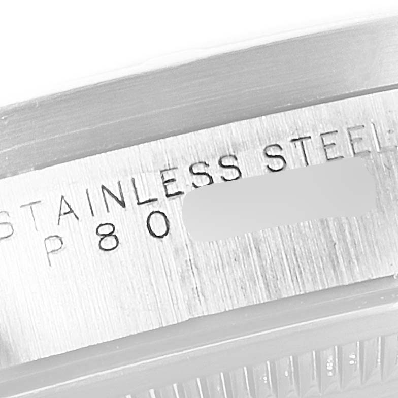 The image shows a close-up of the stainless steel bezel engraving on a Rolex Date 15210 Men's Stainless Steel Blue Dial 15210 Men's Stainless Steel Blue Dial model watch.