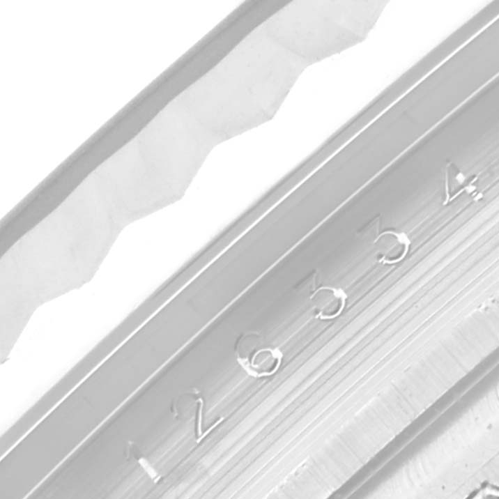 This close-up image shows a portion of the bezel and the engraved serial number of a Rolex Datejust 41 126334 Men
s Stainless Steel Mother of Pearl Dial 126334 Men
s Stainless Steel Mother of Pearl Dial watch.