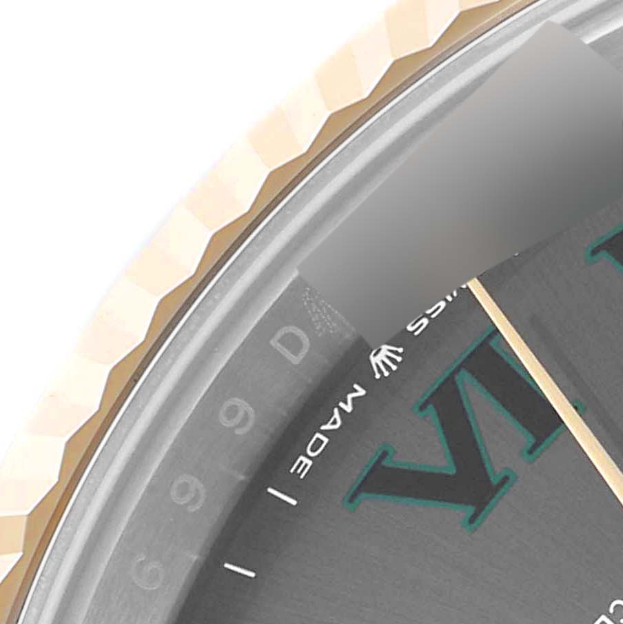 This close-up image of the Rolex Datejust 41 126333 Men's Steel and Gold (two tone) Grey Dial 126333 Men's Steel and Gold (two tone) Grey Dial watch shows part of the bezel, dial, and markers.