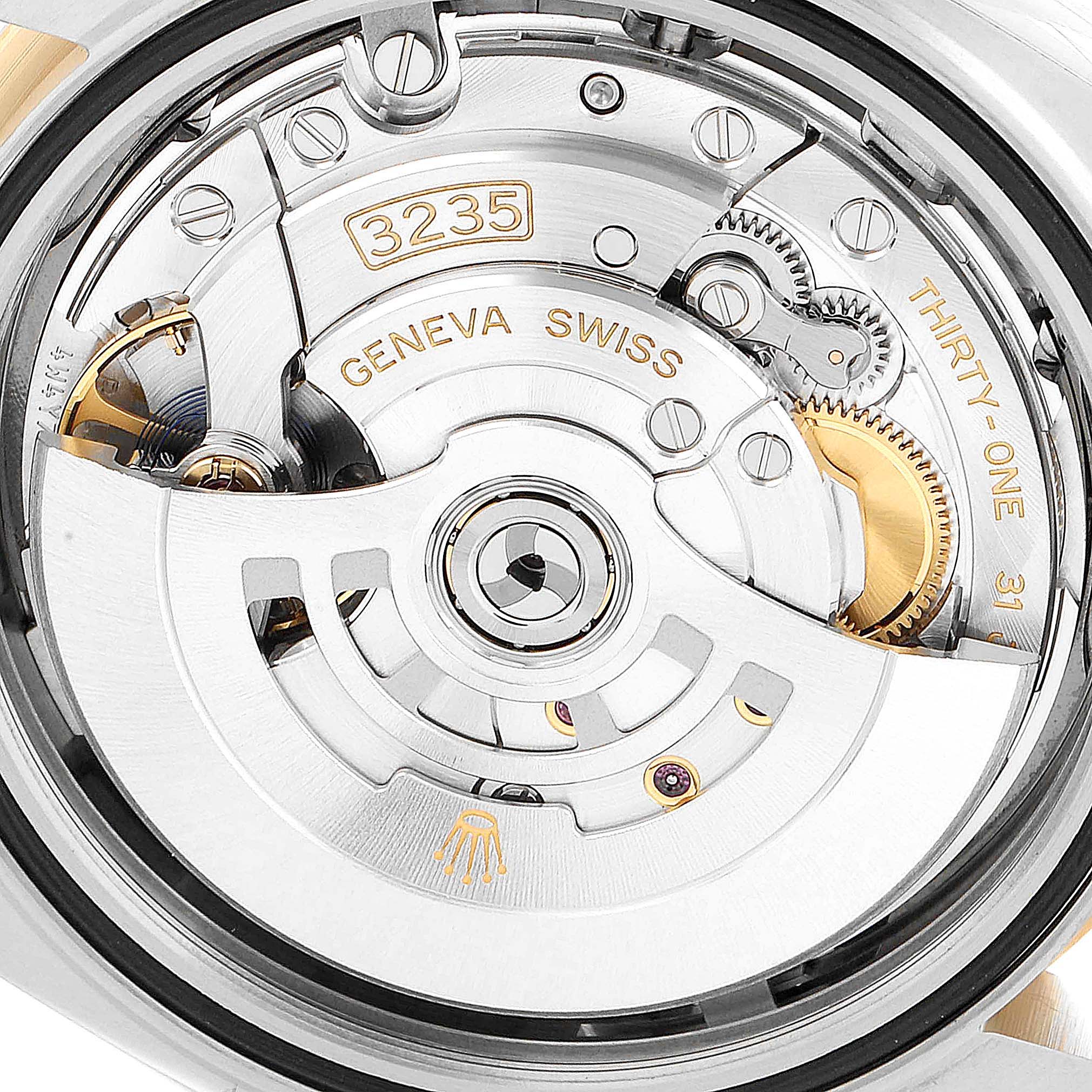 This is an upward close-up view of the back mechanism of the Rolex Datejust 41 126333 Men's Steel and Gold (two tone) Grey Dial 126333 Men's Steel and Gold (two tone) Grey Dial watch, showing intricate components and engravings.