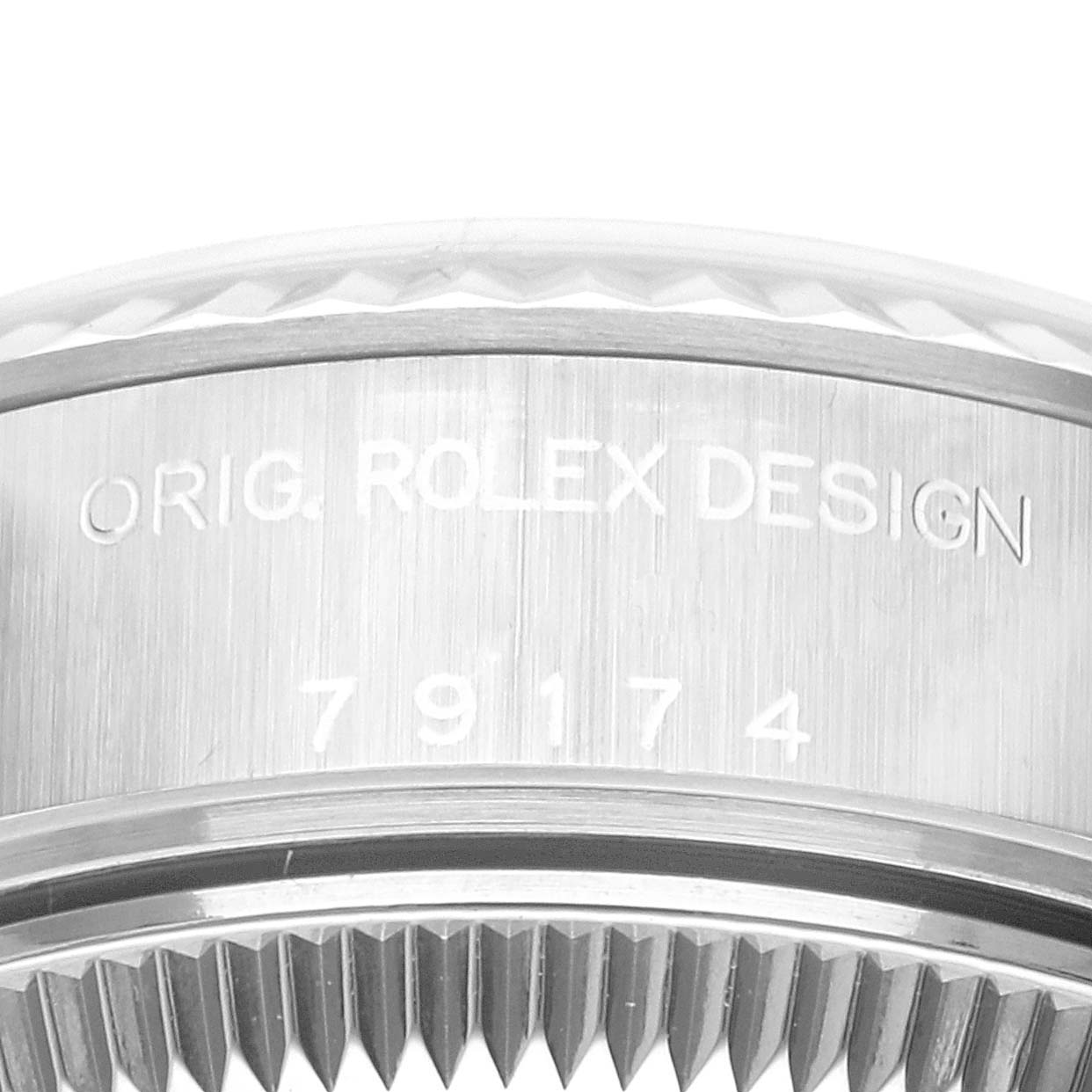 The image shows a close-up of the Rolex Datejust 79174 Women's Stainless Steel Blue Dial 79174 Women's Stainless Steel Blue Dial model's case side, displaying the "ORIG. ROLEX DESIGN" and model number engraving.