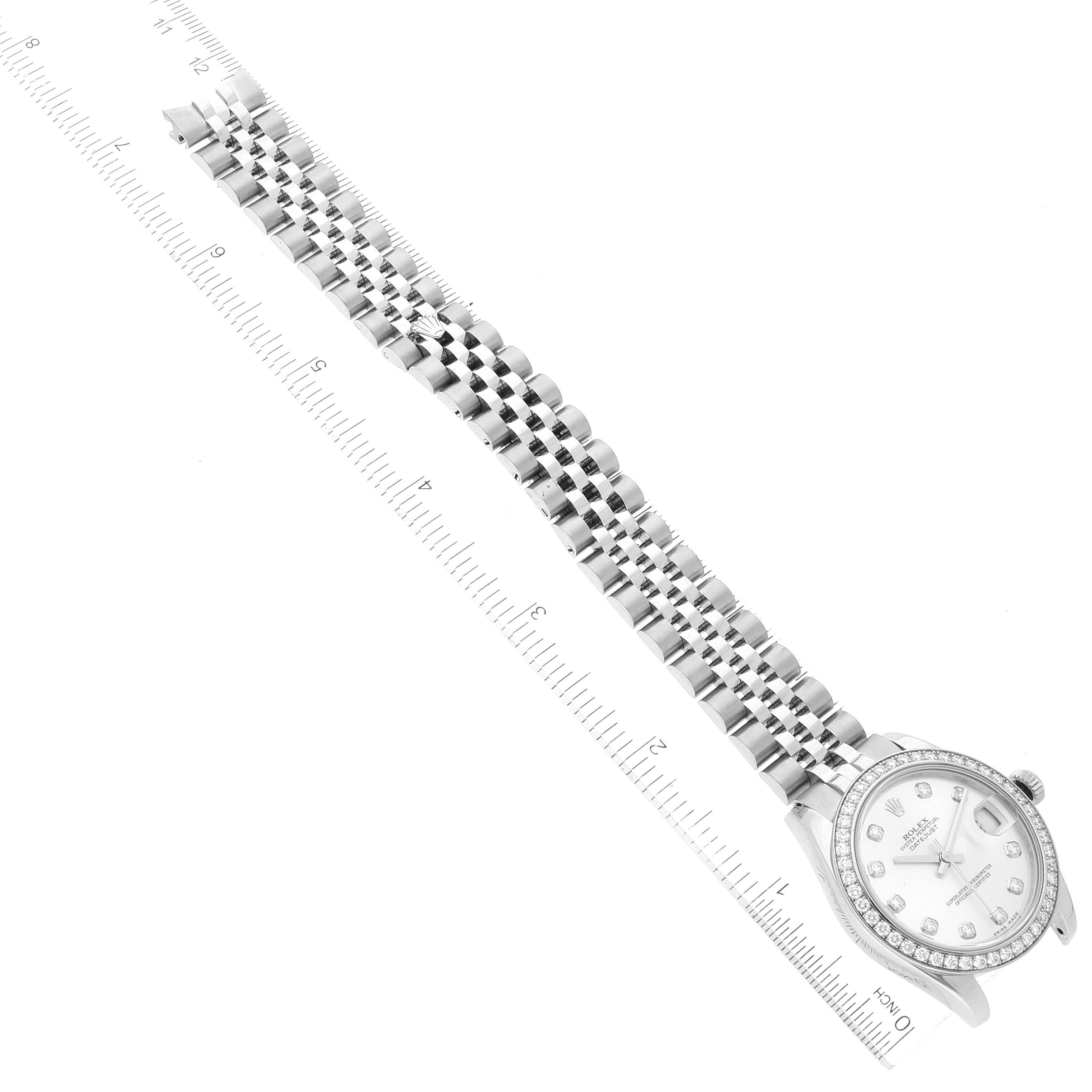 The image shows a right-side view of a Rolex Mid-Size 178384 Women
s Stainless Steel Silver Dial 178384 Women
s Stainless Steel Silver Dial watch, highlighting the face, bezel, and bracelet, alongside measuring rulers.