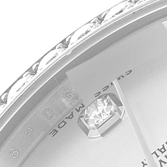 The image shows a close-up angle of a Rolex Mid-Size 178384 Women
s Stainless Steel Silver Dial 178384 Women
s Stainless Steel Silver Dial model watch focusing on a diamond marker and part of the bezel.