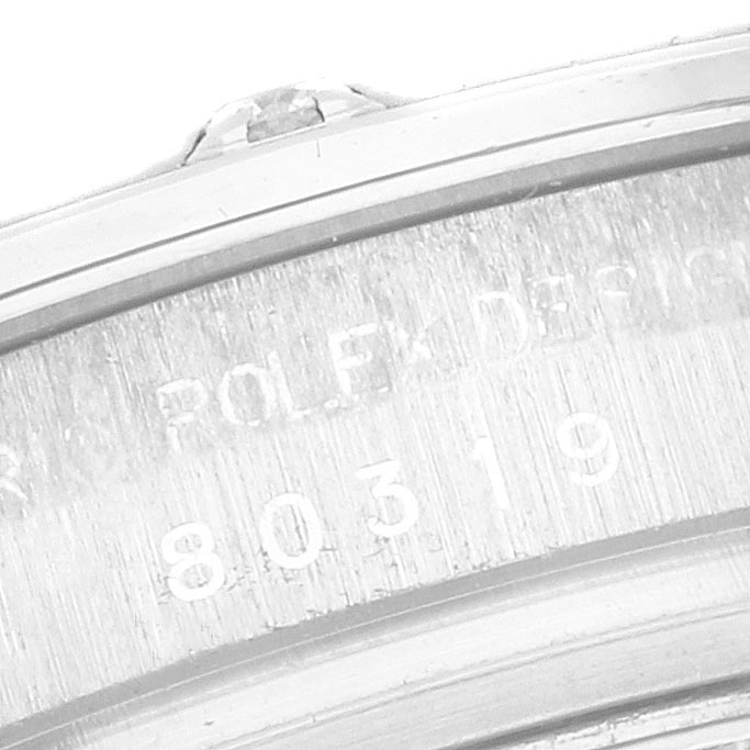 The image shows a detailed close-up of the Pearlmaster model by Rolex, highlighting the engraved serial number on the case edge.