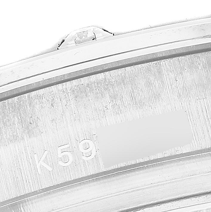 The image shows a close-up of the watch case edge of a Rolex Pearlmaster 80319 Women
s White Gold Silver Dial 80319 Women
s White Gold Silver Dial, highlighting the serial number and part of the bezel.