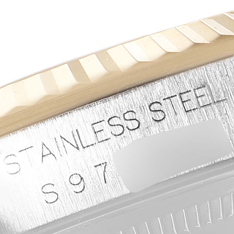 The image shows a close-up of the Rolex Datejust 16233 Men's Steel and Gold (two tone) Black Dial 16233 Men's Steel and Gold (two tone) Black Dial watch's stainless steel case edge and part of its fluted bezel.