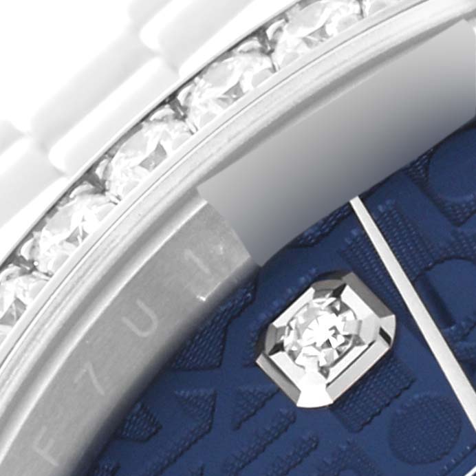 The image shows a close-up angle of the Rolex Datejust 126284 Men's Stainless Steel Blue Dial 126284 Men's Stainless Steel Blue Dial's dial, showcasing a diamond marker and part of the bezel with diamonds.