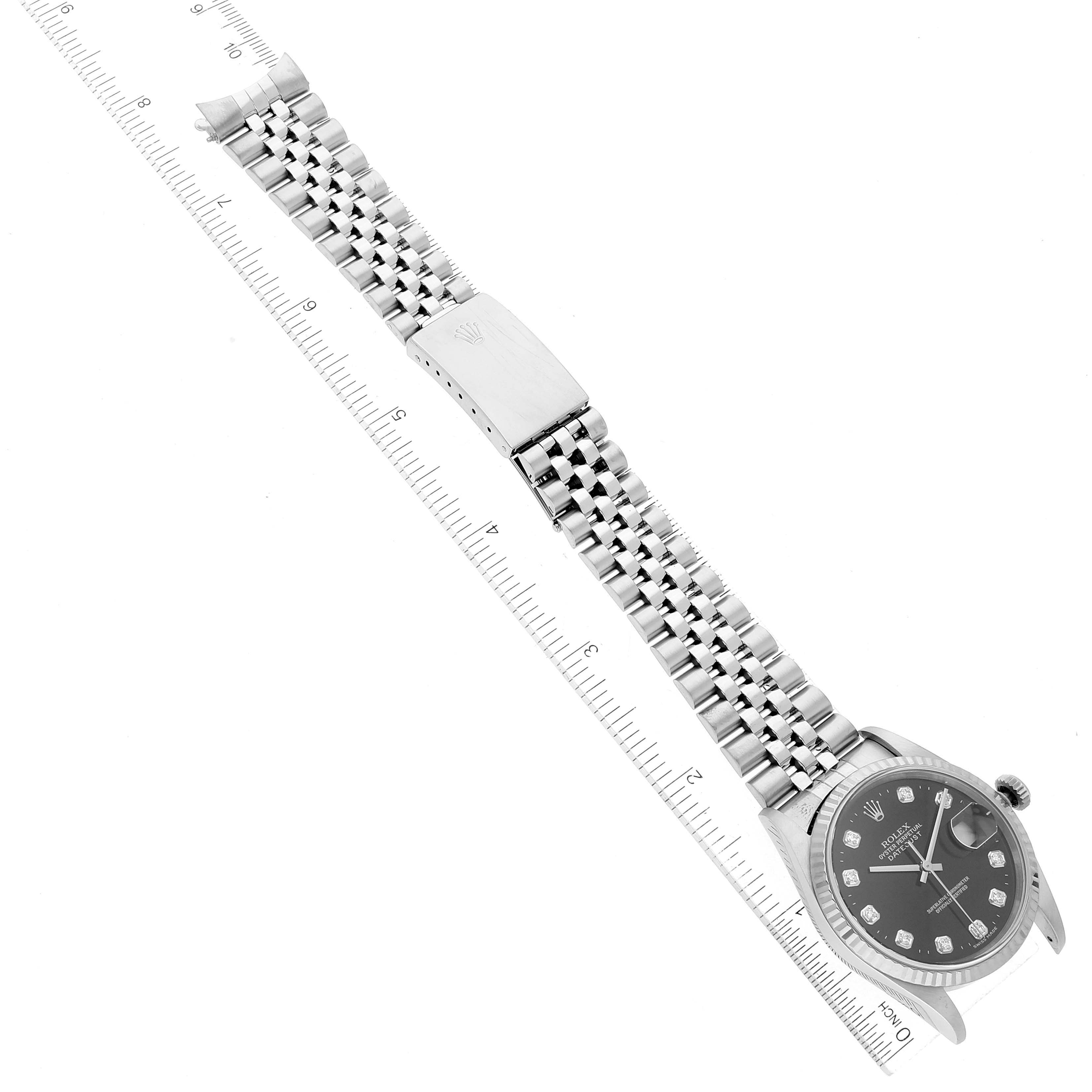 The image shows the front view of a Rolex Datejust 16234 Men's Stainless Steel Black Dial 16234 Men's Stainless Steel Black Dial watch, highlighting the dial, bracelet, clasp, and part of the ruler for scale.