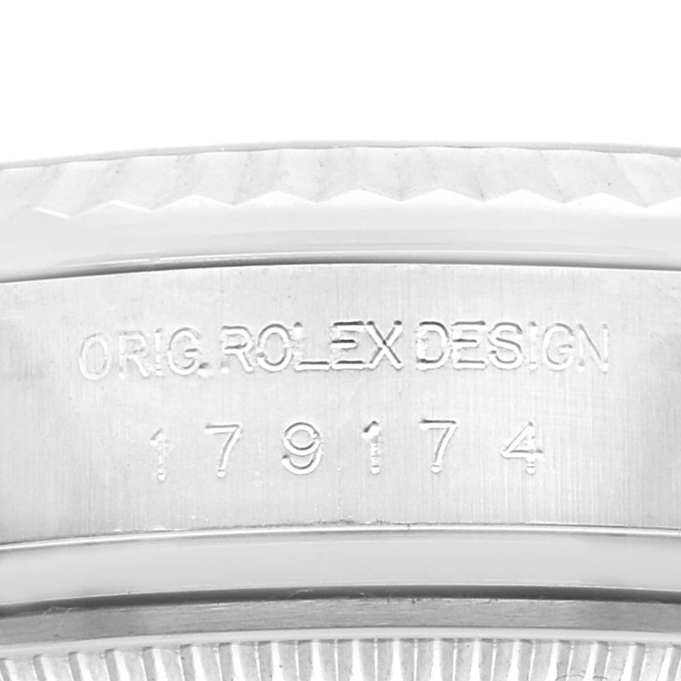 The image shows a close-up of the casing edge and serial number engraving on a Rolex Datejust 179174 Women
s Stainless Steel Black Dial 179174 Women
s Stainless Steel Black Dial watch.