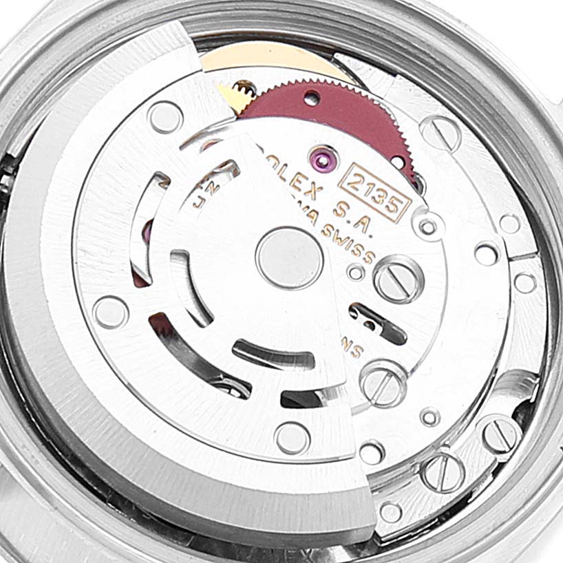 This image shows a close-up of the movement mechanism of a Rolex Datejust 69174 Women
s Stainless Steel Silver Dial 69174 Women
s Stainless Steel Silver Dial watch, emphasizing the rotor and internal components.