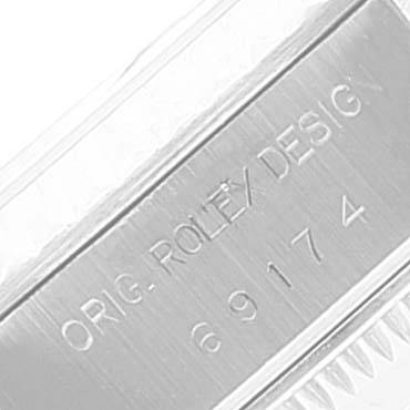 This image shows a close-up of the case side of a Rolex Datejust 69174 Women
s Stainless Steel Silver Dial 69174 Women
s Stainless Steel Silver Dial watch, featuring the "ORIG. ROLEX DESIGN" engraving and serial number.