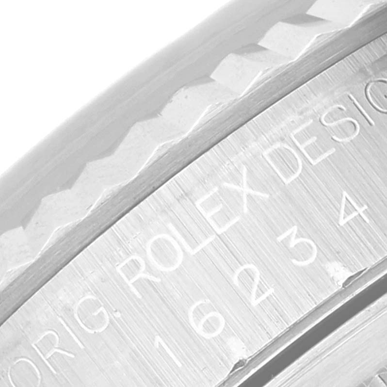 The image shows a close-up of the fluted bezel and engraved text on the case edge of a Rolex Datejust 16234 Men's Stainless Steel Mother of Pearl Dial 16234 Men's Stainless Steel Mother of Pearl Dial watch.
