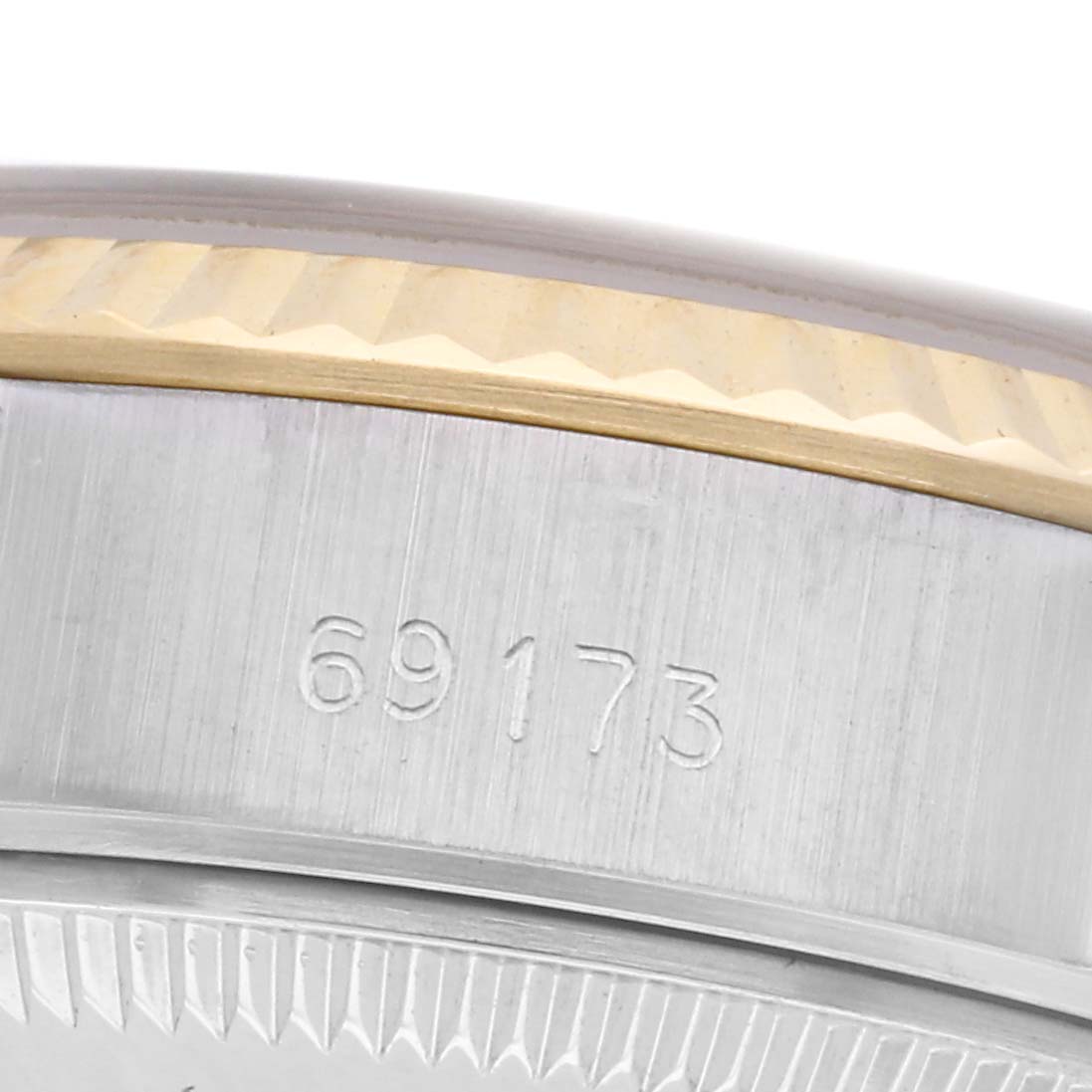 The image shows a close-up angle of the case side of a Rolex Datejust 69173 Women
s Steel and Gold (two tone) Champagne Dial 69173 Women
s Steel and Gold (two tone) Champagne Dial, highlighting the model number and a portion of the bezel.