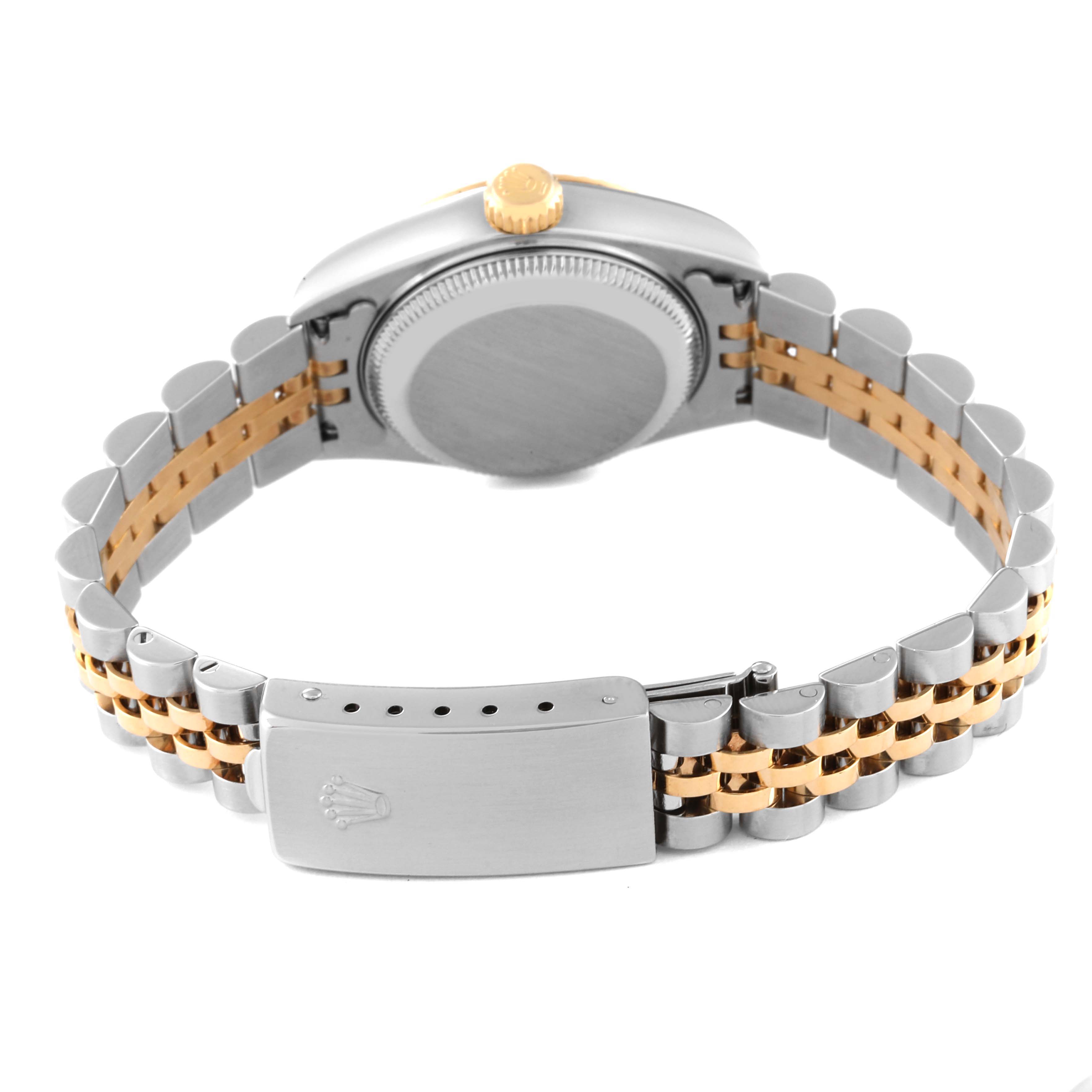 This Rolex Datejust 79173 Women's Steel and Gold (two tone) Champagne Dial 79173 Women's Steel and Gold (two tone) Champagne Dial watch is shown from the rear, highlighting the case back, crown, and bi-color bracelet with the clasp visible.
