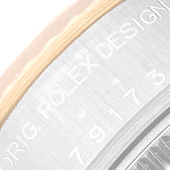This image shows a close-up of the side of the Rolex Datejust 79173 Women's Steel and Gold (two tone) Champagne Dial 79173 Women's Steel and Gold (two tone) Champagne Dial watch, specifically displaying the engraved text on the case.
