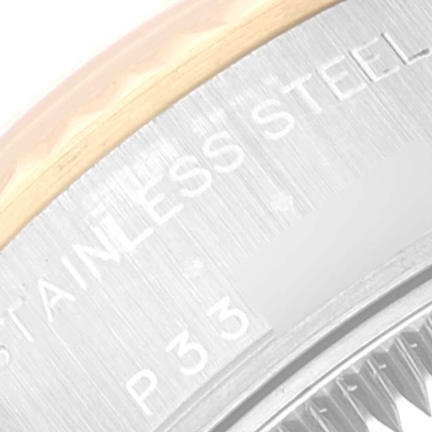 The image shows a close-up angle of the side of a Rolex Datejust 79173 Women's Steel and Gold (two tone) Champagne Dial 79173 Women's Steel and Gold (two tone) Champagne Dial watch, highlighting the stainless steel text and part of the bezel.