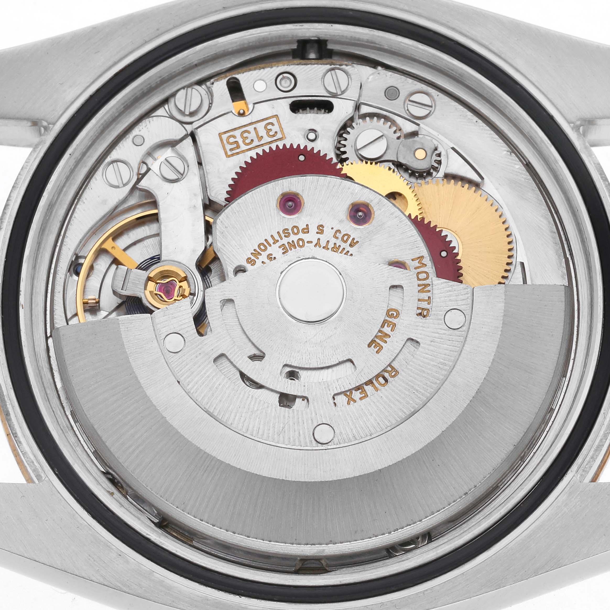 The image shows the movement of a Rolex Datejust 116233 Men's Steel and Gold (two tone) Champagne Dial 116233 Men's Steel and Gold (two tone) Champagne Dial watch from the back, highlighting the rotor and gears.