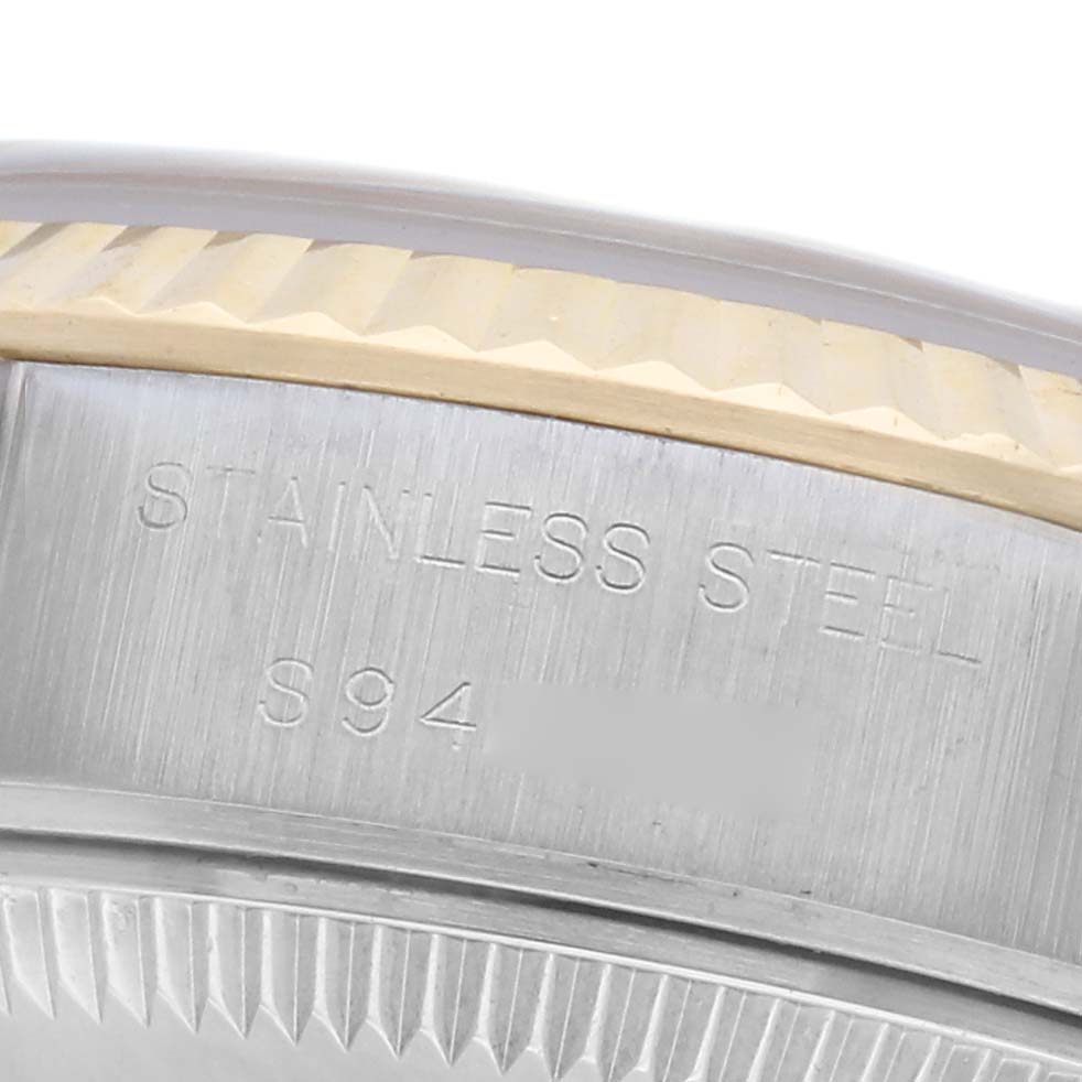 The image shows a close-up of the side of a Rolex Datejust 69173 Women's Steel and Gold (two tone) White Dial 69173 Women's Steel and Gold (two tone) White Dial, highlighting the fluted bezel and material engraving.