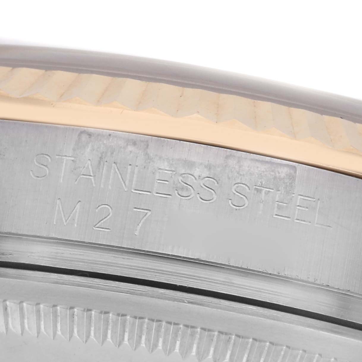 This image shows a close-up of the stainless steel edge and part of the bezel of a Rolex Datejust 116233 Men's Steel and Gold (two tone) White Dial 116233 Men's Steel and Gold (two tone) White Dial watch.
