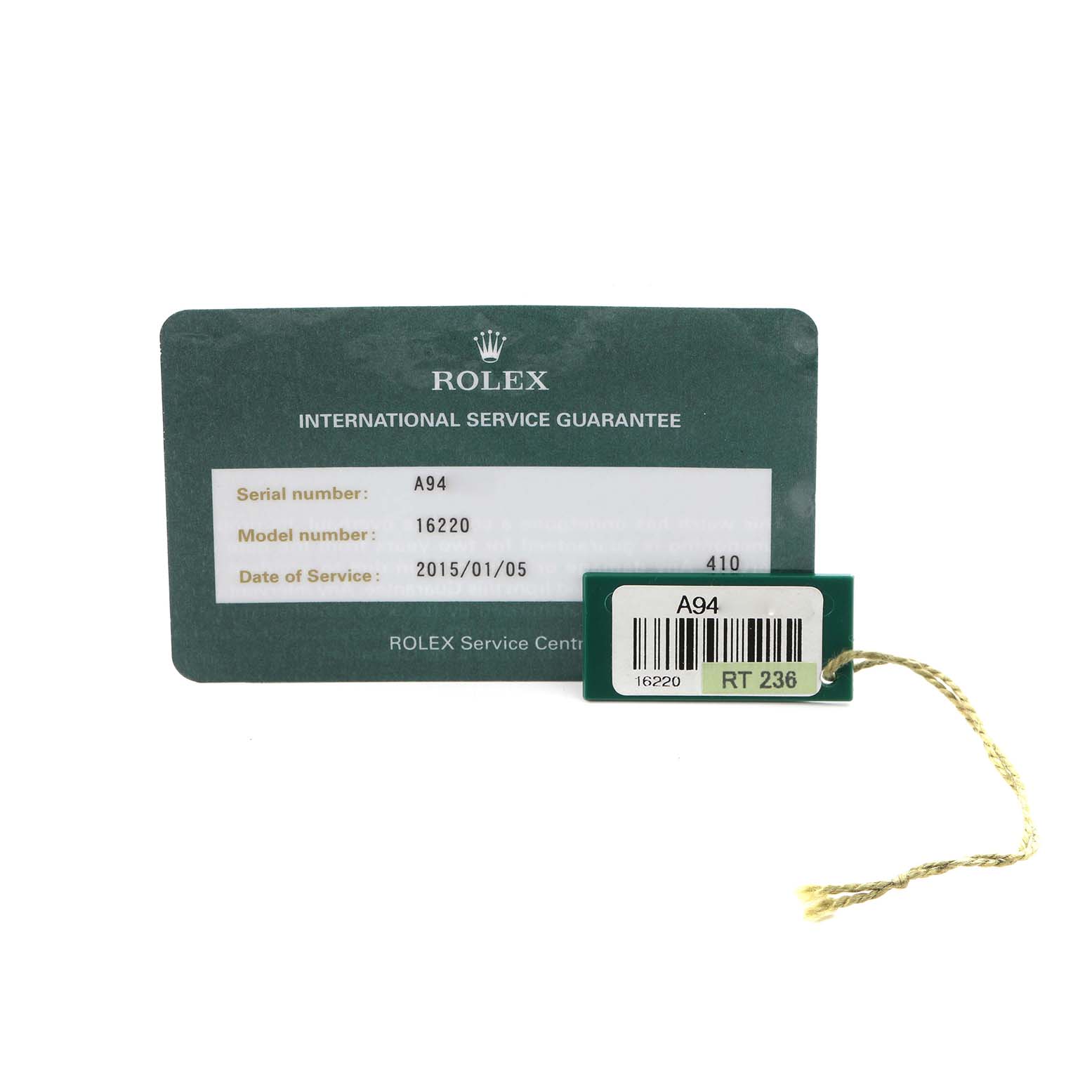 The Rolex Datejust 16220 Men's Stainless Steel White Dial 16220 Men's Stainless Steel White Dial accessories include a service guarantee card and a green tag with details visible.