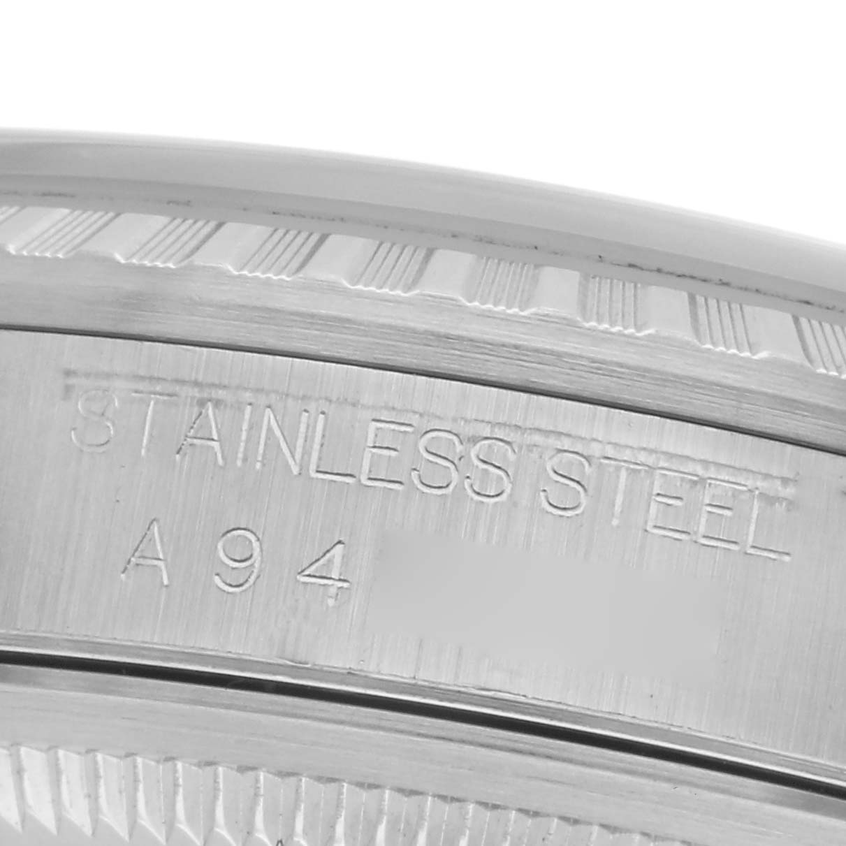 The image shows a close-up of the engraved case side of a stainless steel Rolex Datejust 16220 Men's Stainless Steel White Dial 16220 Men's Stainless Steel White Dial watch.