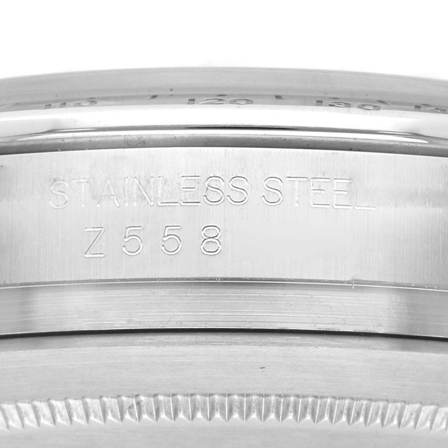 The image shows a close-up of the side of a Rolex Daytona 116520 Men's Stainless Steel Black Dial 116520 Men's Stainless Steel Black Dial watch case, highlighting the "Stainless Steel" engraving.