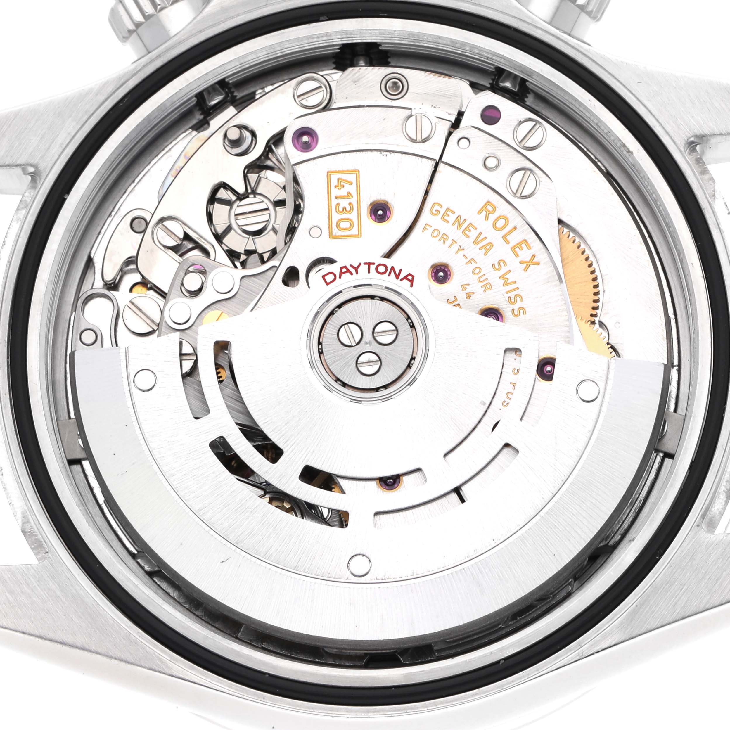 The image shows a close-up view of the Rolex Daytona 116520 Men's Stainless Steel Black Dial 116520 Men's Stainless Steel Black Dial's movement, highlighting internal mechanical parts and engravings.