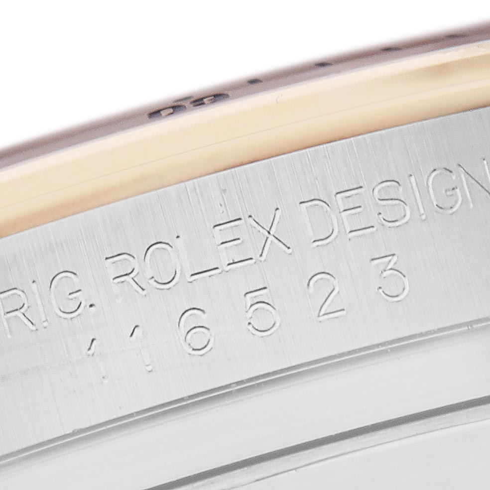 The image shows a close-up of the engraving on the side of the Rolex Daytona 116523 Men's Steel and Gold (two tone) Blue Dial 116523 Men's Steel and Gold (two tone) Blue Dial watch case, highlighting model details.