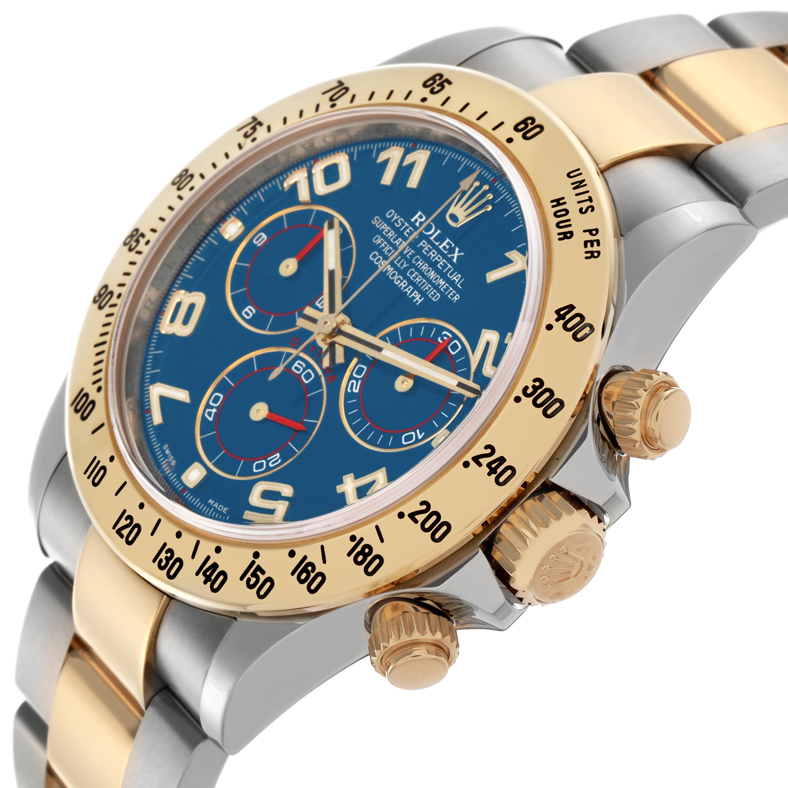 The Rolex Daytona 116523 Men's Steel and Gold (two tone) Blue Dial 116523 Men's Steel and Gold (two tone) Blue Dial watch is shown at an angled side view, highlighting its dial, bezel, and crown with pushers.