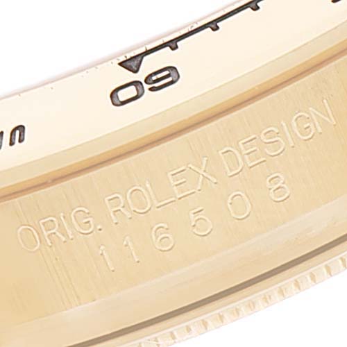 Close-up of the bezel and engravings on a Rolex Daytona 116508 Men's Yellow Gold Champagne Dial 116508 Men's Yellow Gold Champagne Dial watch, showing "ORIG. ROLEX DESIGN" and model number 116508.