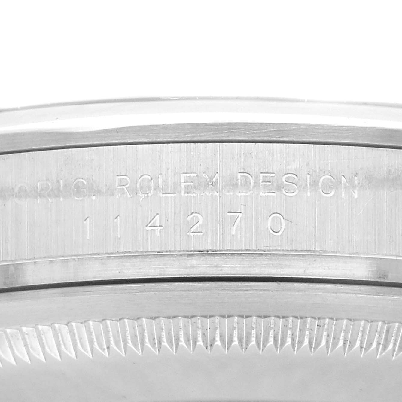 The image shows a close-up of the side of a Rolex Explorer 114270 Men's Stainless Steel Black Dial 114270 Men's Stainless Steel Black Dial watch case, highlighting the engraved model number "114270".