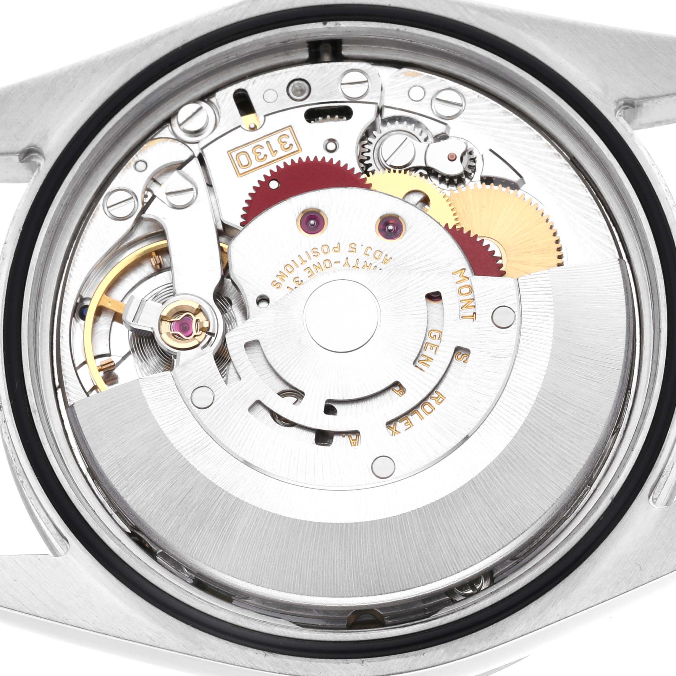 The image shows a close-up view of the movement inside a Rolex Explorer 114270 Men's Stainless Steel Black Dial 114270 Men's Stainless Steel Black Dial watch, highlighting its intricate gears and components.