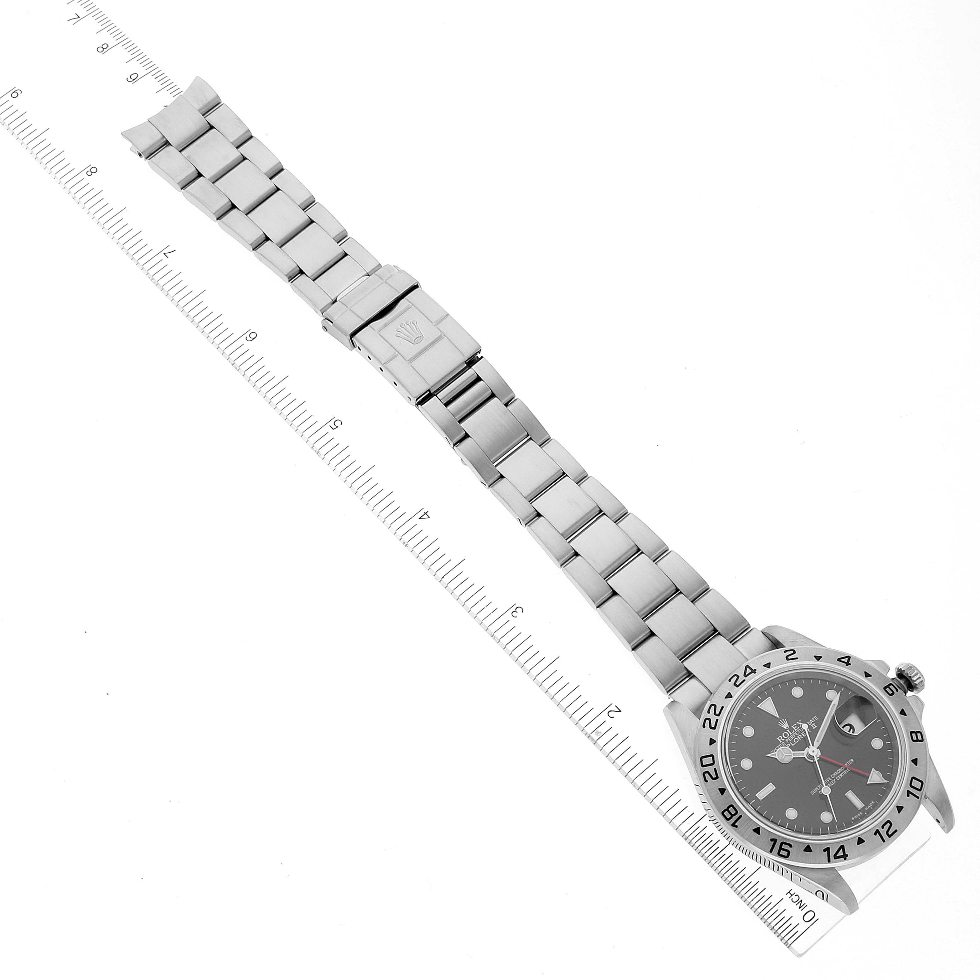 The image shows a Rolex Explorer 16570 Men
s Stainless Steel Black Dial 16570 Men
s Stainless Steel Black Dial watch laid flat, displaying its bracelet, clasp, and face with a ruler beside it for scale.