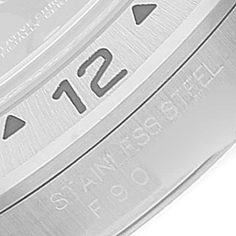 The image shows a close-up of the bezel and part of the case of a Rolex Explorer 16570 Men
s Stainless Steel Black Dial 16570 Men
s Stainless Steel Black Dial watch, highlighting the number 12.