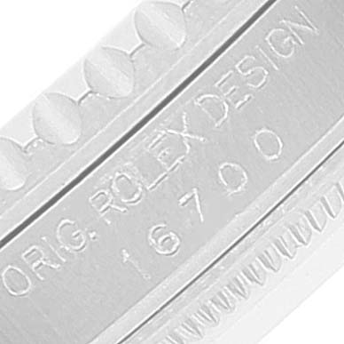 The image shows an engraving on the side of the case of a Rolex GMT-Master 16700 Men
s Stainless Steel Black Dial 16700 Men
s Stainless Steel Black Dial watch, displaying the model number 16700 and "ORIG. ROLEX DESIGN".