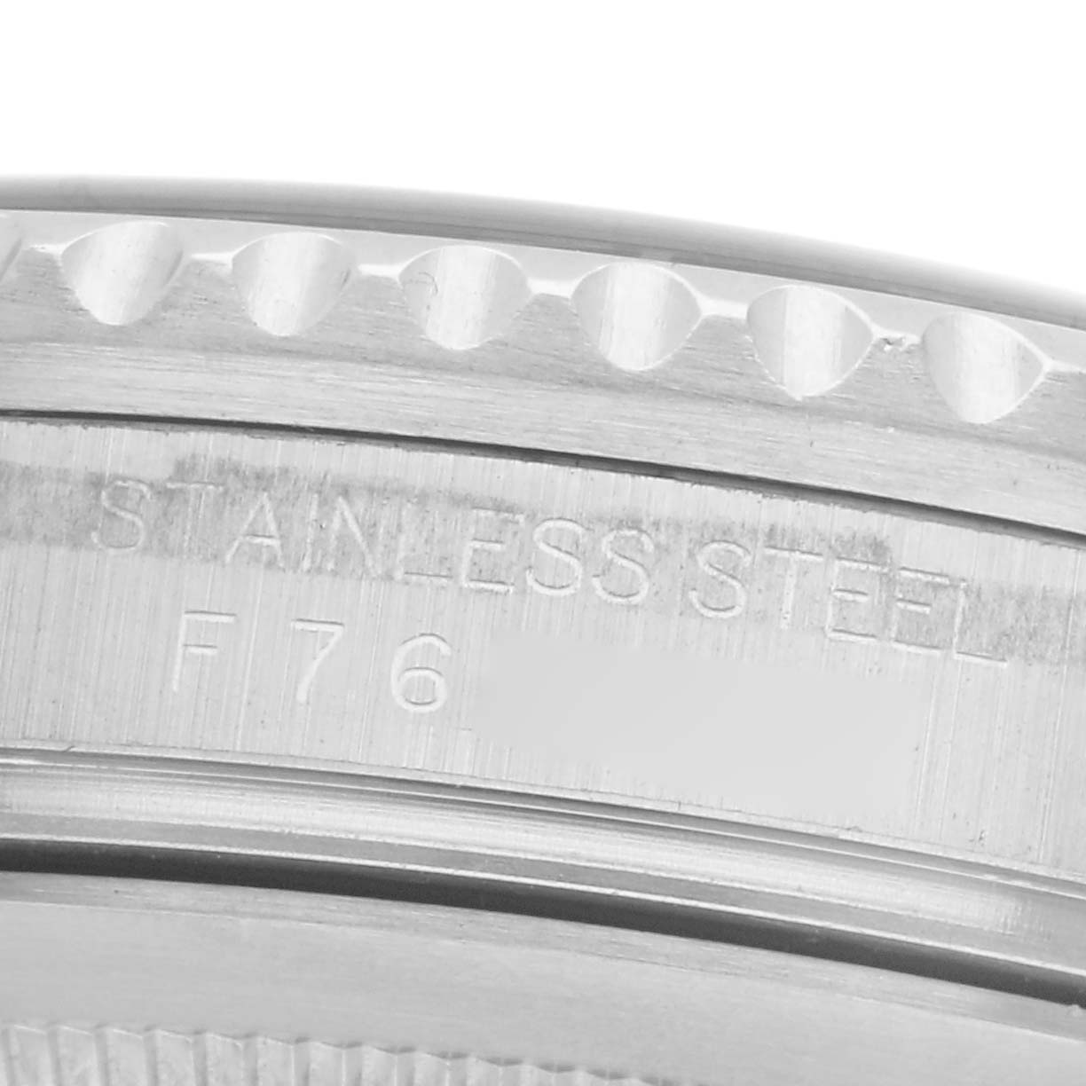 The image shows a close-up of the side of a Rolex GMT-Master 16710 Men's Stainless Steel Black Dial 16710 Men's Stainless Steel Black Dial, highlighting the stainless steel case and engraved details.