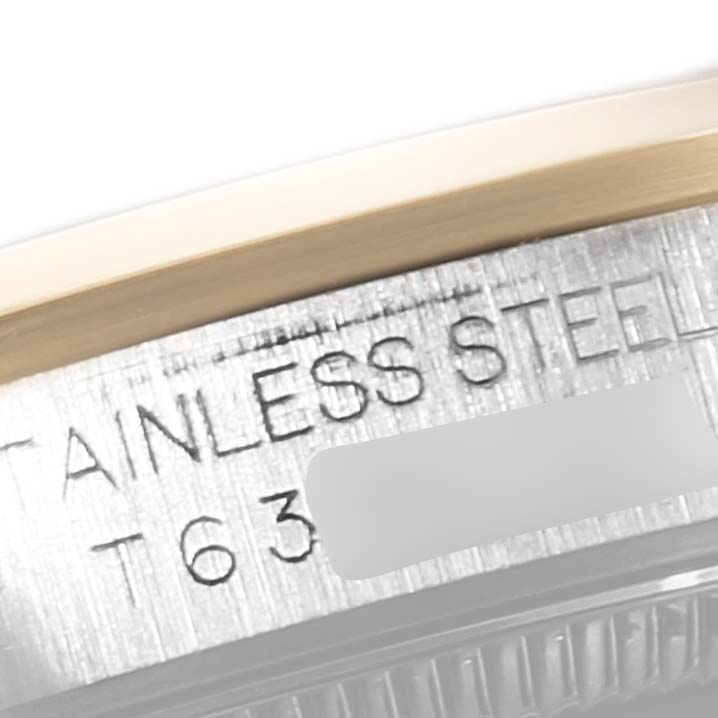 This close-up image shows the side of the case of a Rolex Mid-Size 67483 Women
s Steel and Gold (two tone) Grey Dial 67483 Women
s Steel and Gold (two tone) Grey Dial watch, highlighting its stainless steel construction and partial engraving.
