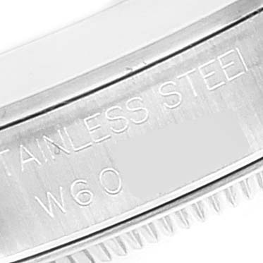 This image shows a close-up of the case back edge of a Mid-Size Rolex watch, highlighting the "STAINLESS STEEL" engraving.