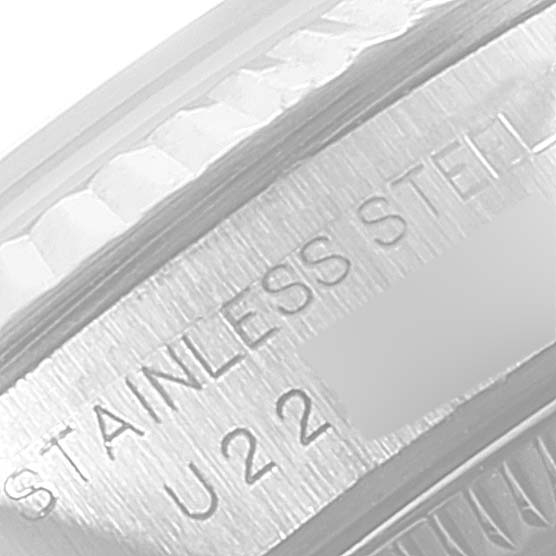 This close-up image shows the engraved "STAINLESS STEEL" marking on the case of a Rolex Oyster Perpetual 67194 Women's Stainless Steel Black Dial 67194 Women's Stainless Steel Black Dial watch.