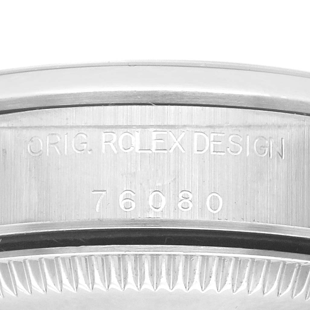 The image shows the case side of a Rolex Oyster Perpetual 76080 Women's Stainless Steel Silver Dial 76080 Women's Stainless Steel Silver Dial with engraved branding and model number.