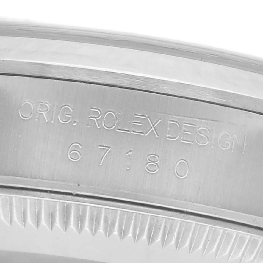 The image shows a close-up of the inner bezel with engraved text on the Rolex Oyster Perpetual 67180 Women's Stainless Steel Pink Dial 67180 Women's Stainless Steel Pink Dial watch.
