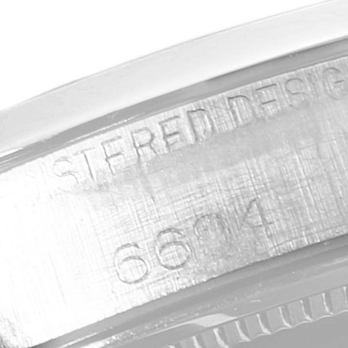 This image shows a close-up of the case back details, including the serial number, of a Rolex Vintage Collection 6694 Men
s Stainless Steel Silver Dial 6694 Men
s Stainless Steel Silver Dial model.